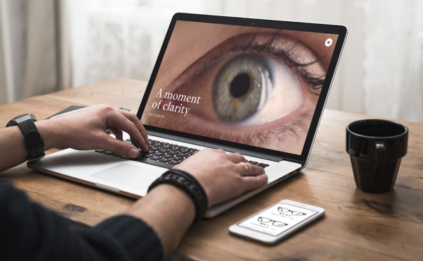 laptop on a desk showing easee online eye exam