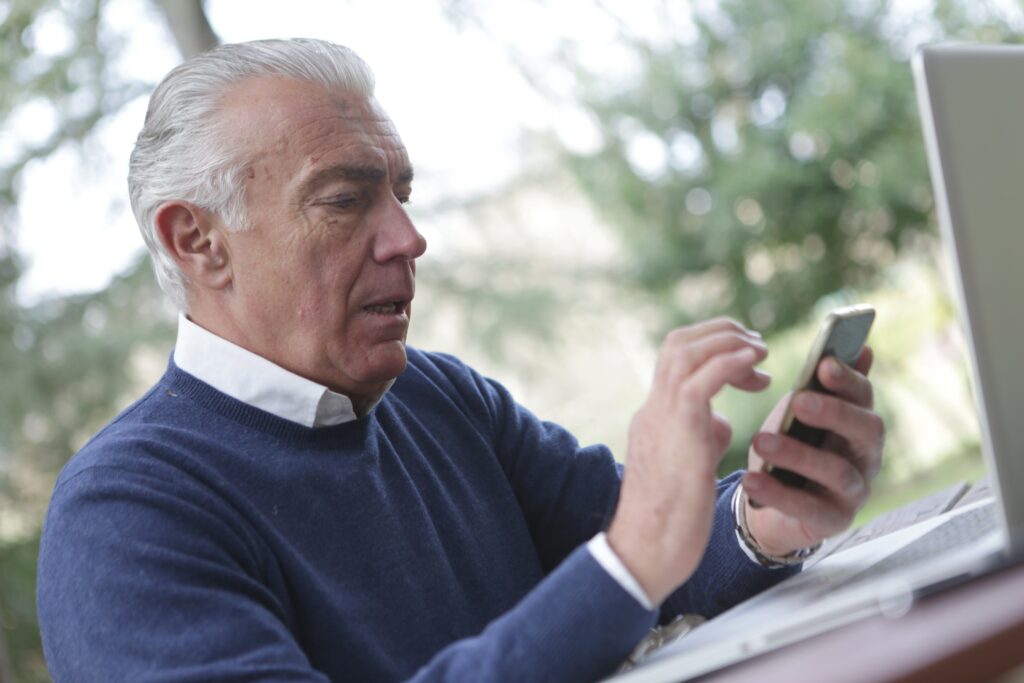 Older man looking at a phone